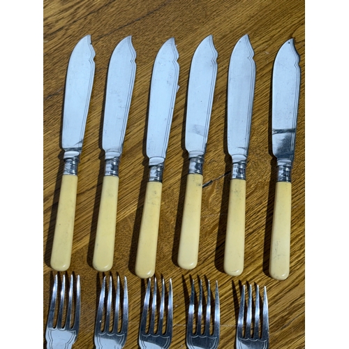 413 - A silver mounted cutlery set.