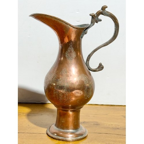 416 - A large Middle Eastern copper pitcher. Late 19th/early 20th century. 37cm.