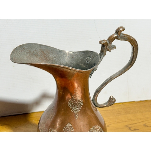 416 - A large Middle Eastern copper pitcher. Late 19th/early 20th century. 37cm.