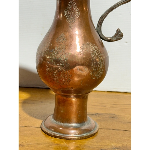 416 - A large Middle Eastern copper pitcher. Late 19th/early 20th century. 37cm.