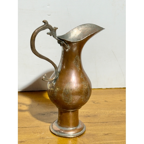 416 - A large Middle Eastern copper pitcher. Late 19th/early 20th century. 37cm.