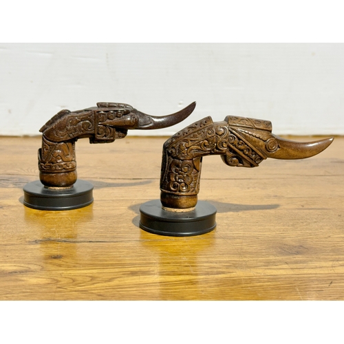 388 - A pair of keris hilt coat hooks. 15cm.