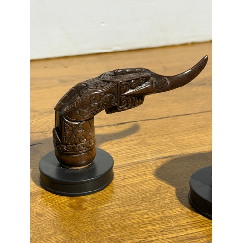 388 - A pair of keris hilt coat hooks. 15cm.