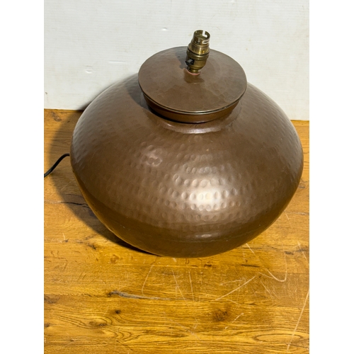 288 - A large Indian hammered copper lamp. 37x39cm.