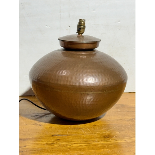 288 - A large Indian hammered copper lamp. 37x39cm.