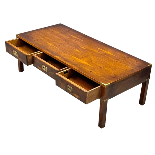 257 - A Campaign Style Yew Wood Coffee Table. With three drawers and three faux drawers. 122x56x41cm.