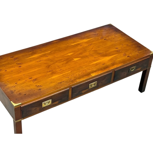 257 - A Campaign Style Yew Wood Coffee Table. With three drawers and three faux drawers. 122x56x41cm.