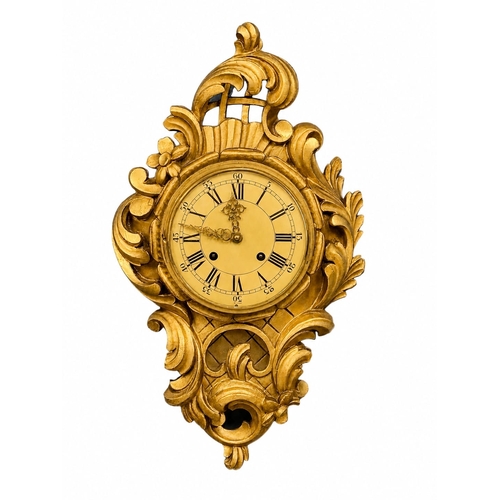 218 - A German Giltwood Rococo Style Wall Clock. Early 20th Century. 30x55cm.