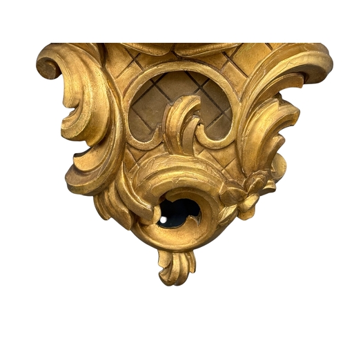 218 - A German Giltwood Rococo Style Wall Clock. Early 20th Century. 30x55cm.
