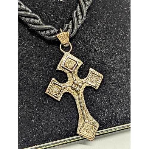 669 - A necklace with silver cross pendant by Joanna Repton