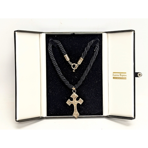 669 - A necklace with silver cross pendant by Joanna Repton