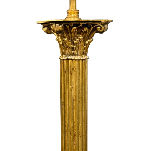 213 - A Brass Standard Lamp. Mid 20th Century. With Corinthian style column and four lion paw feet. 162cm.