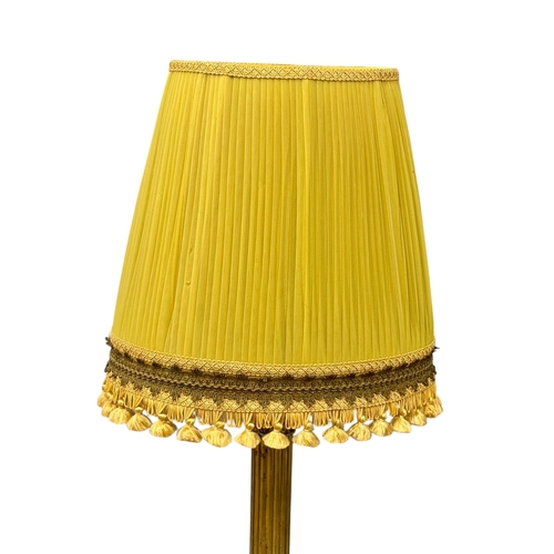 213 - A Brass Standard Lamp. Mid 20th Century. With Corinthian style column and four lion paw feet. 162cm.