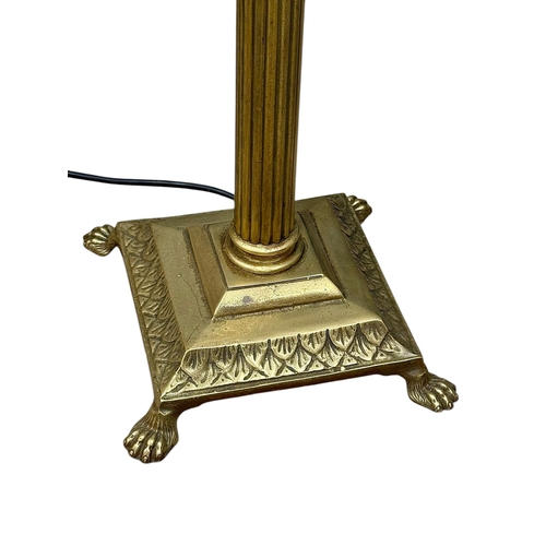 213 - A Brass Standard Lamp. Mid 20th Century. With Corinthian style column and four lion paw feet. 162cm.