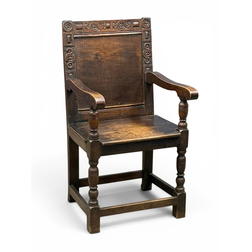 231 - An English Oak Wainscot Style Armchair. C.1880-90, Late 19th Century. With Chiesmans Ltd label.