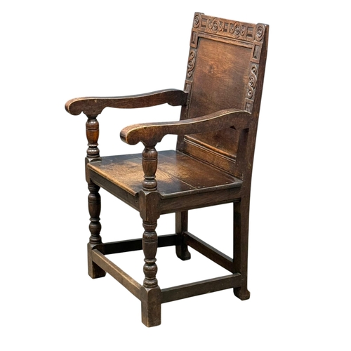 231 - An English Oak Wainscot Style Armchair. C.1880-90, Late 19th Century. With Chiesmans Ltd label.