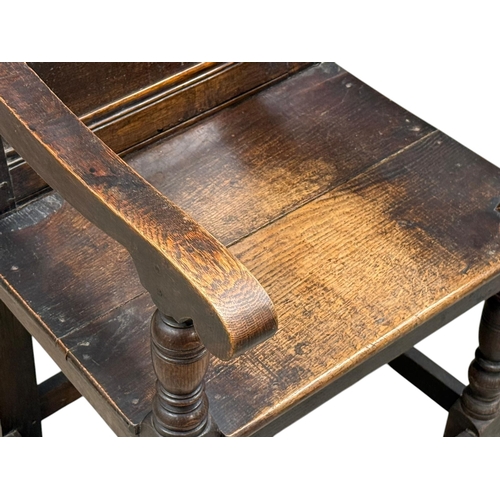 231 - An English Oak Wainscot Style Armchair. C.1880-90, Late 19th Century. With Chiesmans Ltd label.