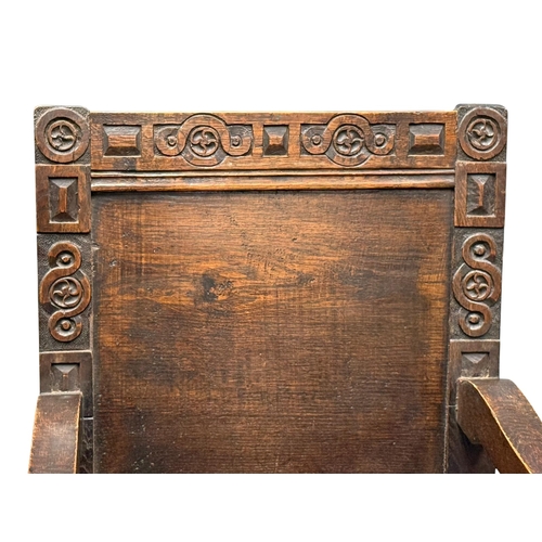 231 - An English Oak Wainscot Style Armchair. C.1880-90, Late 19th Century. With Chiesmans Ltd label.