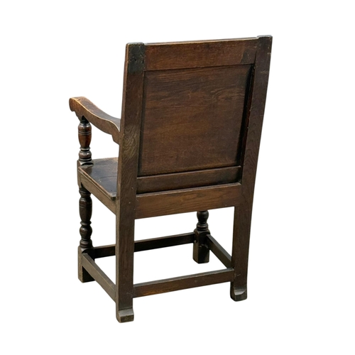 231 - An English Oak Wainscot Style Armchair. C.1880-90, Late 19th Century. With Chiesmans Ltd label.