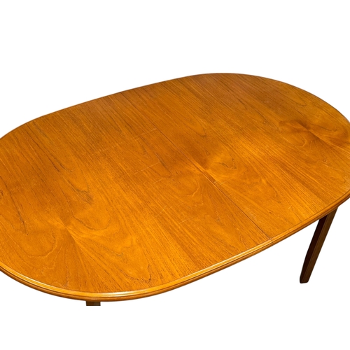 279 - A Teak Extending Dining Table and Six Chairs by Meredew. C.1970. 145x94x74cm. Open 188x94x74cm.