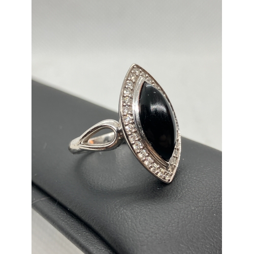 180 - 18ct white gold designer onyx and diamond ring