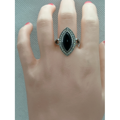 180 - 18ct white gold designer onyx and diamond ring