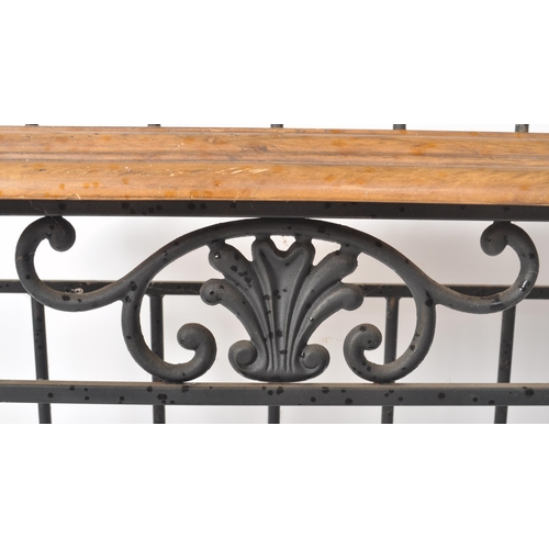 17 - A contemporary French style bakers rack having a wrought iron frame finished in black with paneled o... 