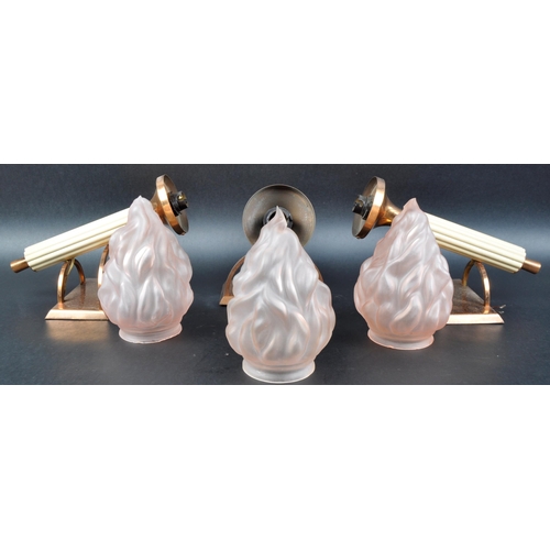 24 - A matching set of three 20th Century Art Deco copper plated wall sconces with each having peach fros... 