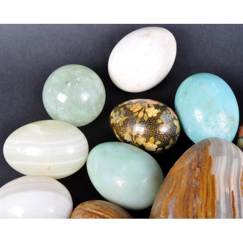 35 - A large collection of approx; 90 mineral, clay and carved wooden eggs. Multiple marble egg examples ... 