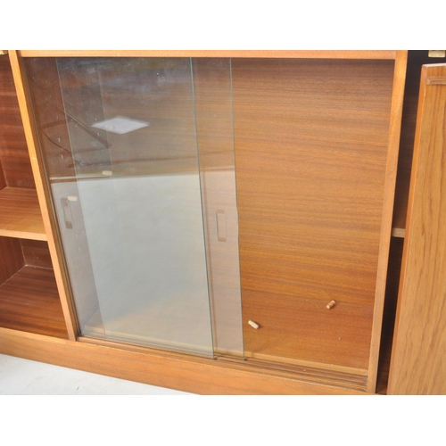 51 - A retro 20th Century Scandinavian teak bookcase / display cabinet having two central sliding glass d... 