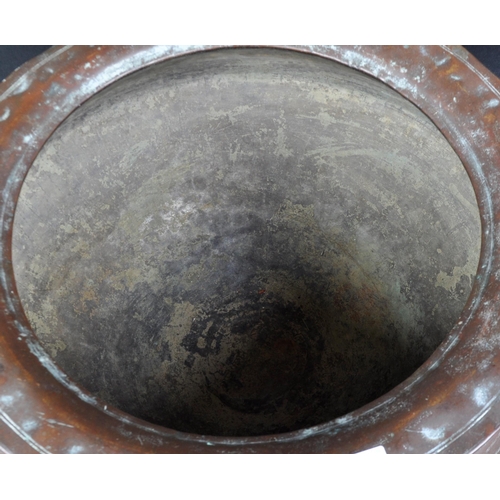 7 - An 18th Century Indonesian copper serving pot of bulbous circular form having a flat circular rim ov... 