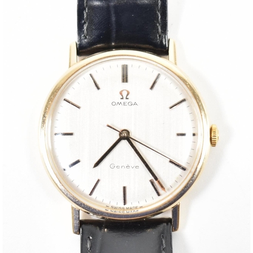 200 - An Omega Geneve 9ct gold wrist watch. The watch having a round face with a brushed dial having baton... 