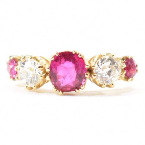 202 - A gold ruby and diamond five stone ring.  The ring set with a central round cut ruby flanked by two ... 