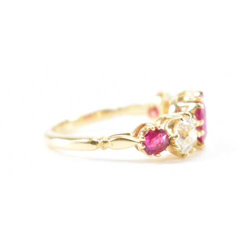 202 - A gold ruby and diamond five stone ring.  The ring set with a central round cut ruby flanked by two ... 