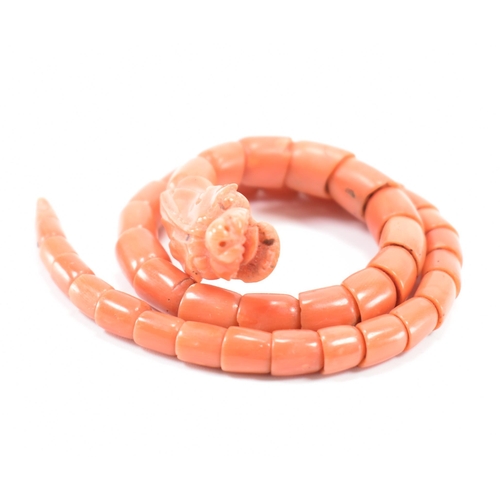 204 - A 19th century coral serpent bangle. The serpent / snake bangle formed of carved overlocking coral b... 