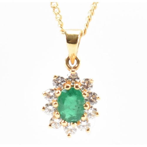 205 - A hallmarked 18ct gold emerald and diamond cluster pendant necklace.  Weight 3.2g. Estimated diamond... 