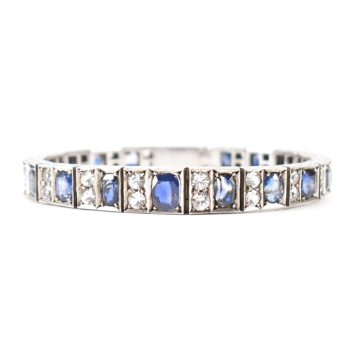 210 - An Art deco white metal sapphire and white stone bracelet. The bracelet constructed from hinged pane... 