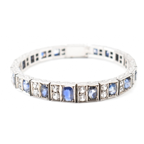 210 - An Art deco white metal sapphire and white stone bracelet. The bracelet constructed from hinged pane... 