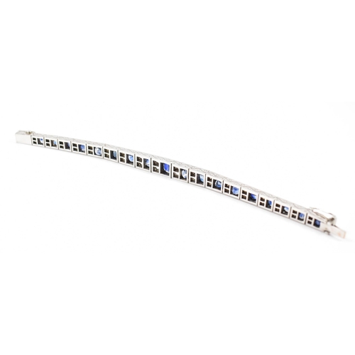 210 - An Art deco white metal sapphire and white stone bracelet. The bracelet constructed from hinged pane... 