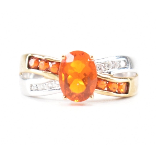 211 - A hallmarked 9ct gold fire opal. The ring being set with an oval cut fire opal to the centre within ... 