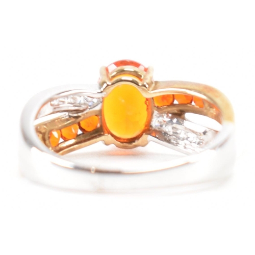 211 - A hallmarked 9ct gold fire opal. The ring being set with an oval cut fire opal to the centre within ... 