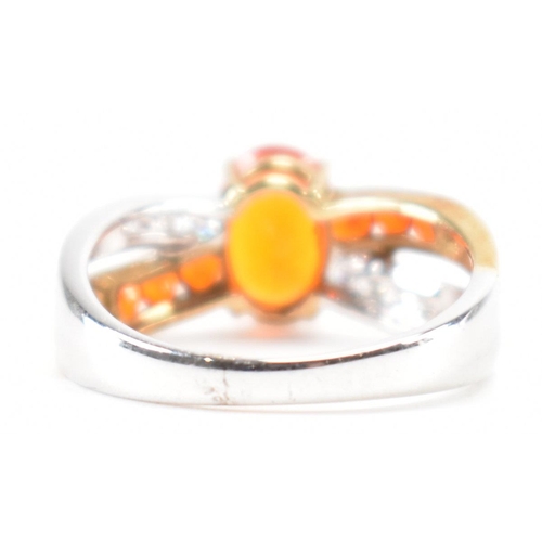 211 - A hallmarked 9ct gold fire opal. The ring being set with an oval cut fire opal to the centre within ... 