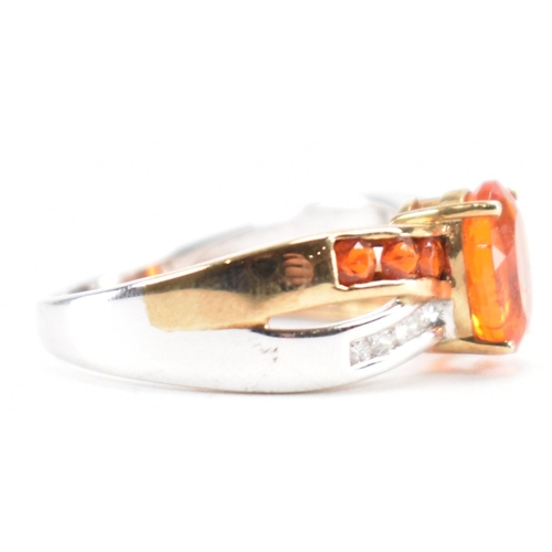 211 - A hallmarked 9ct gold fire opal. The ring being set with an oval cut fire opal to the centre within ... 