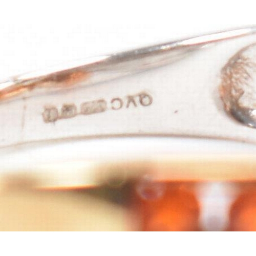 211 - A hallmarked 9ct gold fire opal. The ring being set with an oval cut fire opal to the centre within ... 