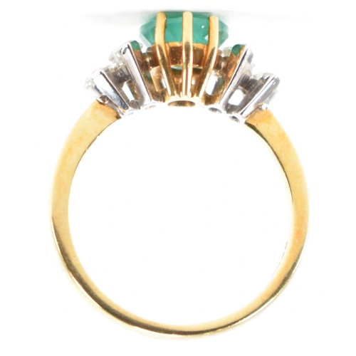 212 - A hallmarked 18ct gold synthetic emerald & diamond ring. The ring set with a central oval synthetic ... 