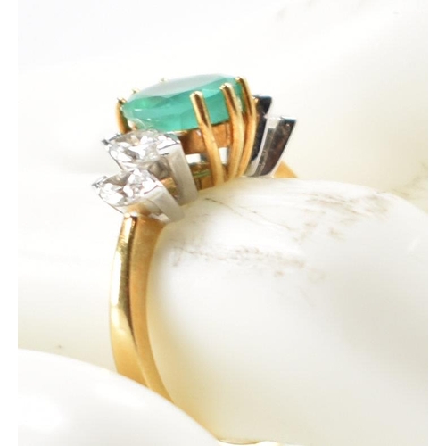 212 - A hallmarked 18ct gold synthetic emerald & diamond ring. The ring set with a central oval synthetic ... 