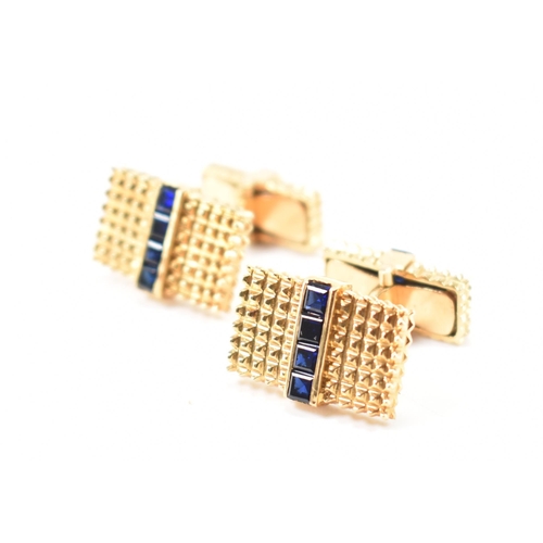 214 - A pair of 18ct gold and synthetic sapphire cufflinks. The cufflinks formed of graduating heads each ... 