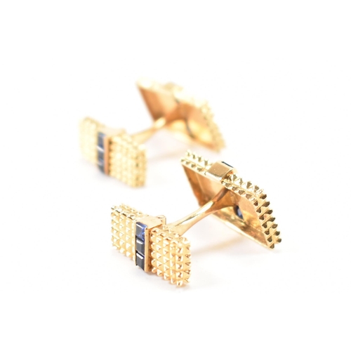 214 - A pair of 18ct gold and synthetic sapphire cufflinks. The cufflinks formed of graduating heads each ... 