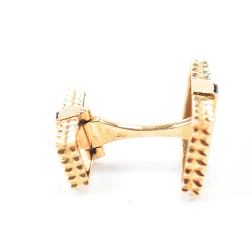 214 - A pair of 18ct gold and synthetic sapphire cufflinks. The cufflinks formed of graduating heads each ... 