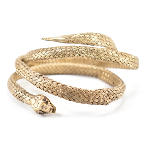 220 - A 19th Century Victorian Russian silver gilt snake bangle. The bangle made from woven gilt silver wi... 